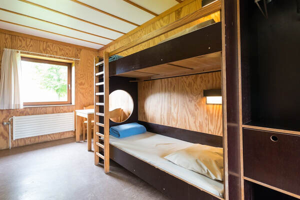 Houten stapelbedden en een klimrek